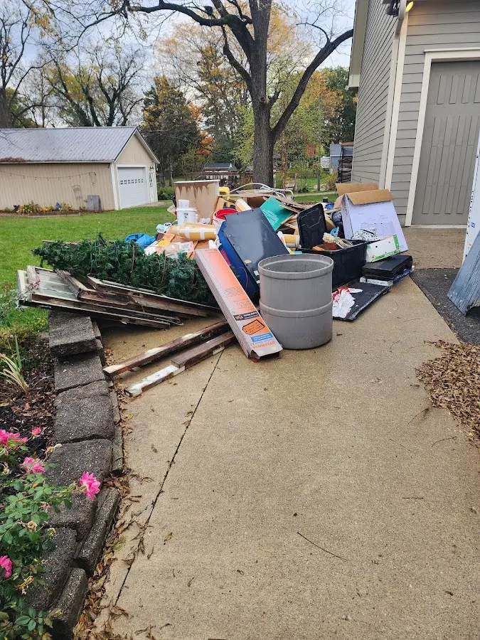 Dumpster being loaded with debris for 10 Yard Dumpster Rental in Jonesboro